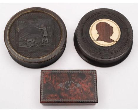 A 19th century pressed horn snuff box:  of circular outline, the lid decorated with a rough shooting scene, 7.5cm. diameter, 