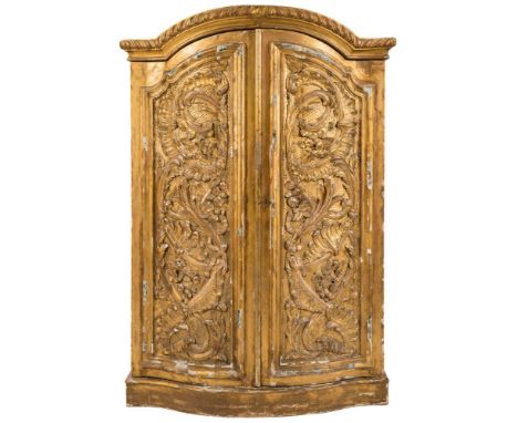 A 19th century Continental carved giltwood domed and bow-fronted armoire: with a moulded and gadrooned cornice, enclosed by a