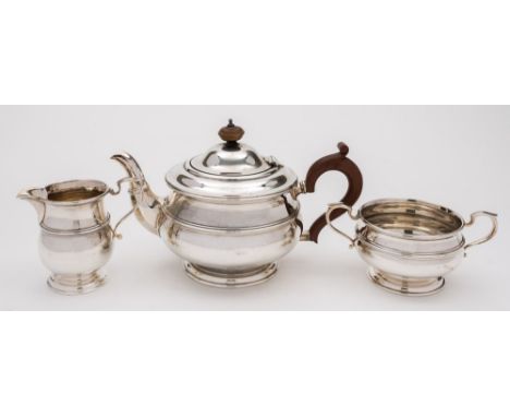 A George V silver three-piece tea service, maker Brook & Sons, Sheffield, 1923: of plain circular form with reeded girdle, to