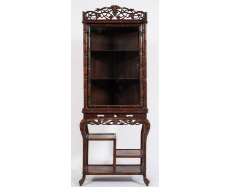 A Chinese carved hardwood simulated bamboo upright display cabinet on stand:, with pierced cresting decorated with leaves and