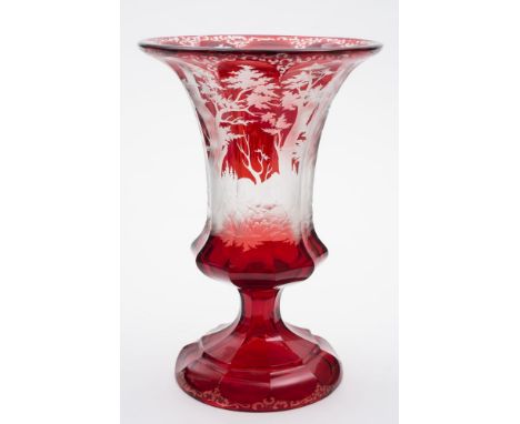 A Bohemian ruby stained glass vase: of fluted bell shape, engraved with a continuous hunting scene with a stag, doe and hunte