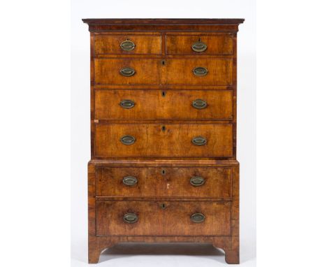 An 18th Century walnut chest on chest:, the upper part with a moulded cornice, containing two short and three long drawers, t