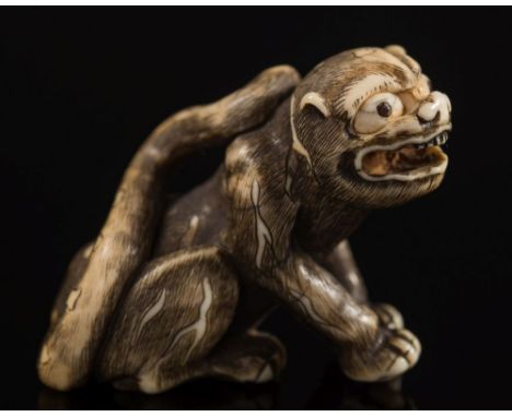 A Japanese carved ivory netsuke of a recumbent warthog: with inset eyes, signed, Meiji period, 4.5cm. long together with anot