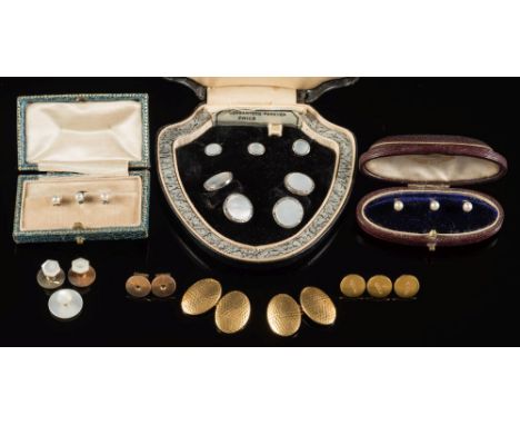 A pair of 18ct gold oval panel cuff-links of hammered finish design with three matching dress studs:, a pair of mother of pea