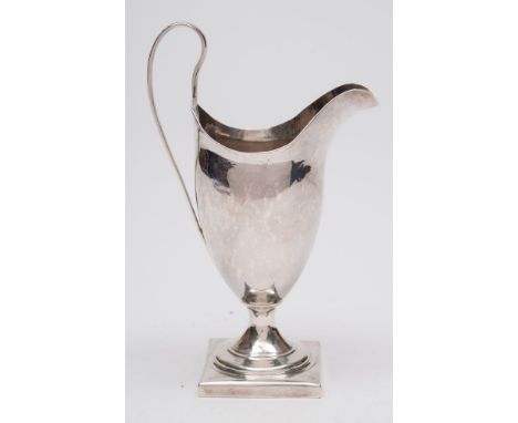 A George III silver cream jug, maker Peter and Ann Bateman, London, 1790: initialled, of helmet-shaped outline, raised on a s