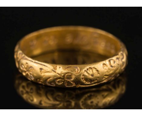 An 18th century gold posy ring:, chased with floral motifs, inscribed inside 'No treasure to a true friend', ring size K 1/2.