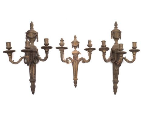 A pair of gilt metal three-branch wall lights: each backplate with flaming urn and garland decorated fluted columns,  with ac