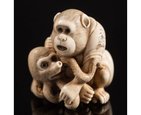 A Japanese carved ivory netsuke, depicting a monkey holding a young octopus: both with inset eyes, unsigned, 19th century, 3.
