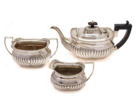 An Edward VII  silver three-piece tea service, maker Thomas Hayes, Birmingham, 1901: of barge-shaped outline, with gadrooned 
