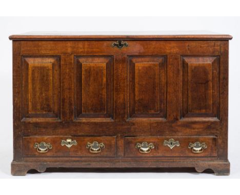 An 18th Century oak dower chest:, the rectangular hinged moulded top enclosing an interior with lidded candle box, the fielde