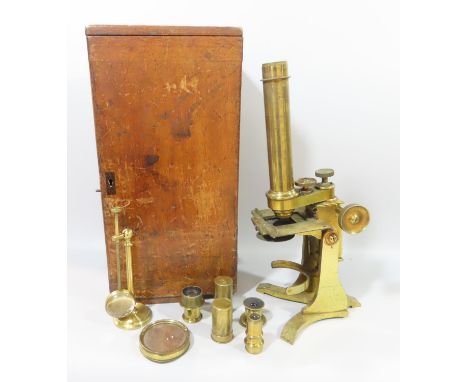 An early 19th century brass Baker of High Holborn microscope, with a selection eye pieces lenses all housed in a wooden box.