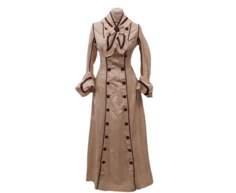 Edwardian ladies dress in a dark cream cotton with contrasting brown piping and trim. Dress has front opening with a double b