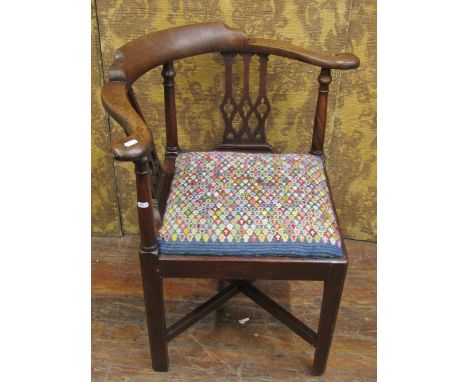 A Georgian walnut corner chair with Gothic tracery splats and hand worked tapestry seat 
