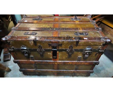 A 19th century American wooden lathe banded steamer trunk with steel fittings, raised on later castors, 62cm high x 84cm x 52