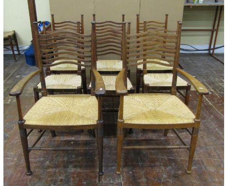 A set of eight (6+2) Arts &amp; Crafts dining chairs by William Birch in oak, with pierced wavy splat ladder backs all with g