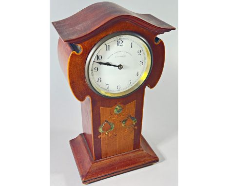 An Edwardian mahogany mantle clock in the Art Nouveau style, the enamelled dial with black Arabic numerals, marked ‘Thomas Ar