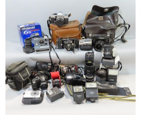A selection of late 20th century photographic equipment, including a Canon A-1, a Praktika LTL camera, a selection of lenses,