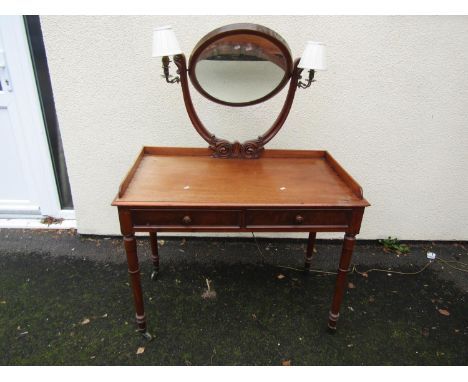 A late Victorian dressing table with integrated girandole lights on turned supports 