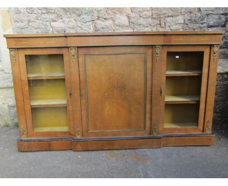 A Victorian walnut breakfront credenza enclosed by a central solid door, flanked by further glass doors with string inlaid de