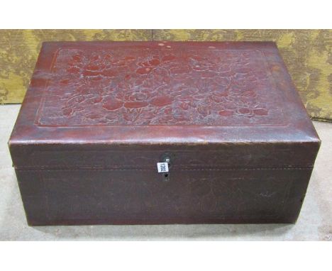 A Chinese leather overlaid trunk with embossed floral detail, 26cm high x 66cm x 44cm