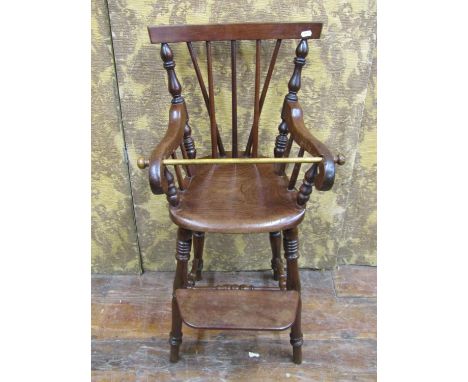 A 19th century mahogany child's high chair with stick back, turned supports, complete with step