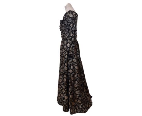 Late 19th century Victorian dress composed of full length skirt and long sleeved stayed bodice; fabric is  silver and black s