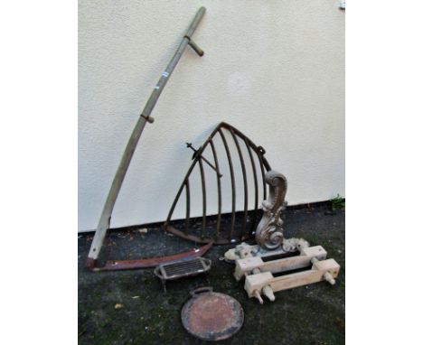 Iron hay manger, cast iron griddle and small burner and a scythe, together with a carved wood bracket