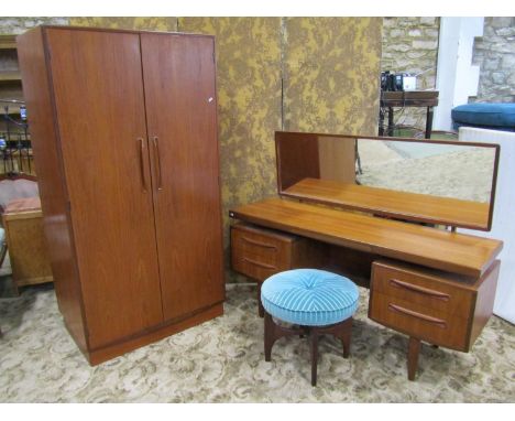 A G Plan teak bedroom pair comprising a two door wardrobe and a kneehole dressing table with floating top and matching stool 