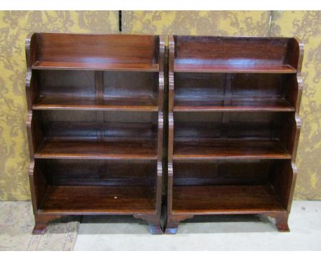 A pair of regency style mahogany dwarf waterfall bookcases with reeded outline and bracket supports, 92cm high x 64cm x 29cm 