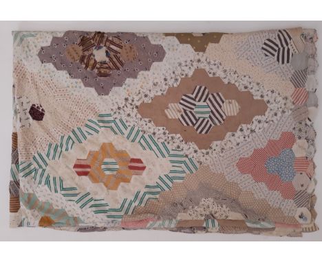 A large vintage patchwork  panel/ quilt composed of hexagon patches of various printed cottons forming  a diamond shaped desi