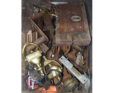 A collection of door furniture and iron fittings including hinges, knockers, etc