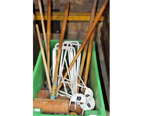 A collection of vintage croquet equipment to include markers, hoops, balls, etc