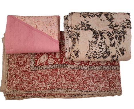 Three vintage quilts including a reversible quilt of printed cotton quilted by hand with running stitch, 200x170cm (AF), a la