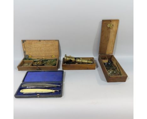 An antique brass field microscope, 2 sets of portable scales with small weights and a box with two cut throat razors.