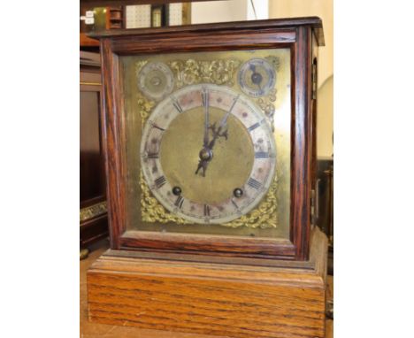 An oak cased bracket clock, with silvered chapter ring and subsidiary dials, 30 x 24cm overall.