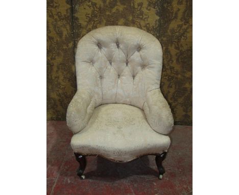 A Victorian button back drawing room chair for re-upholstery raised on cabriole supports 