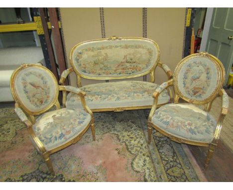 Late 18th/early 19th century gilt and tapestry panelled three piece suite the moulded framework enclosing panels depicting bi