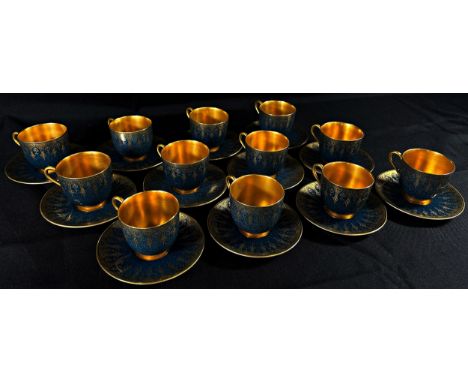 A Royal Worcester cabinet porcelain coffee set, comprising eight cans and saucers, with gilt borders on powder blue grounds, 