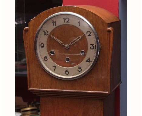 Mid-20th century triple barrel floor standing clock, the arched case with long plain trunk on a shaped plinth base to a chrom