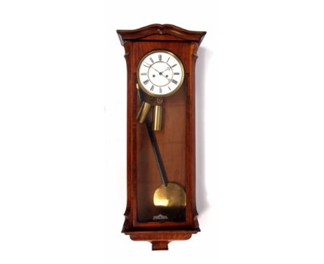 Late 19th century walnut cased twin weight driven Vienna type wall clock with shaped pediment, glazed and hinged door on moul