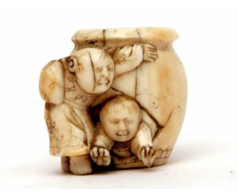 Late 19th/early 20th century ivory netsuke modelled as two children playing with a barrel, 3cms high  