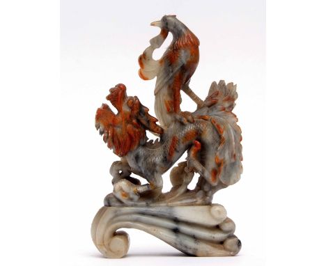 Chinese soapstone carving of a dragon with eagle type bird on its back, the dragon and bird picked out in red on a scroll typ