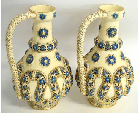 Pair of Continental reticulated faience ewers by Fischer Budapest (Zsolnay), decorated in relief with blue starred and gilt d
