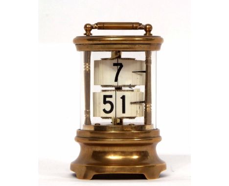 Early 20th century brass cased Ticket clock, the cylindrical case with carry handle and glazed body with waisted base and fit