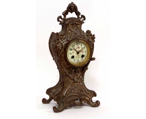 Early 20th century French base metal cased mantel clock, the waisted case with applied floral and thistle detail on scrolling