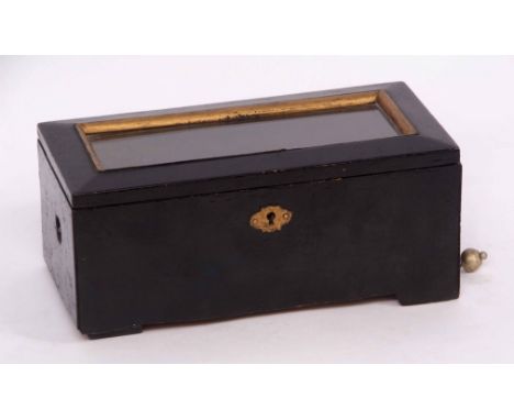 Late 19th century Swiss black painted single tune music box, the hinged and glazed cover with bevelled borders and plain body