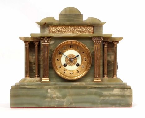 Early 20th century green onyx and gilt metal mounted mantel clock, the architectural case with shaped pediment and plinth bas