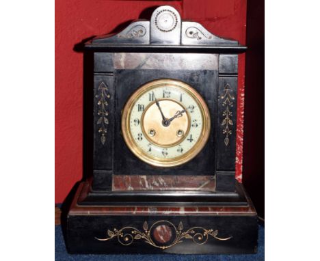 Late 19th century black and variegated rouge marble mantel clock, the plinth shaped case with shaped pediment to a cast bezel