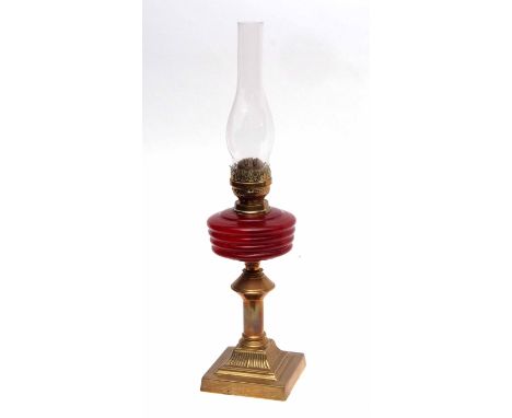 Brass lamp with pink cranberry style glaze and glass chimney 