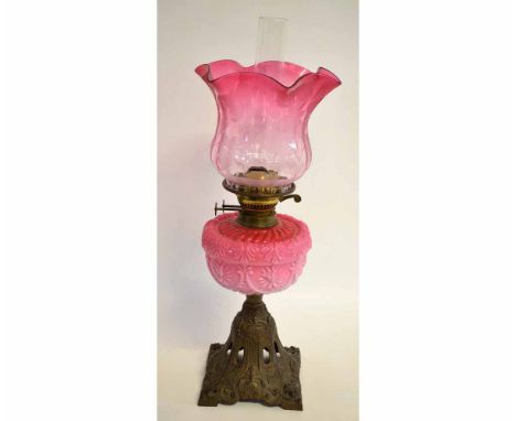Large brass lamp, late 19th century, with pink glass reservoir and shade with floral decoration  